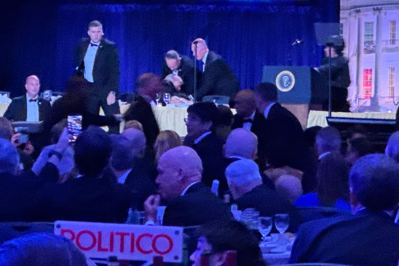 Security agents evacuating the US President from an event