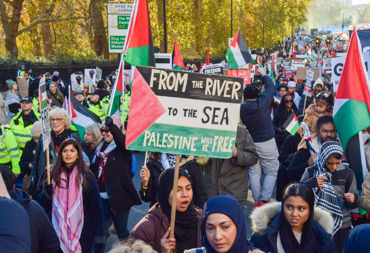 A protester holds a 'From the river to the sea, Palestine will be free' placard during the demonstration