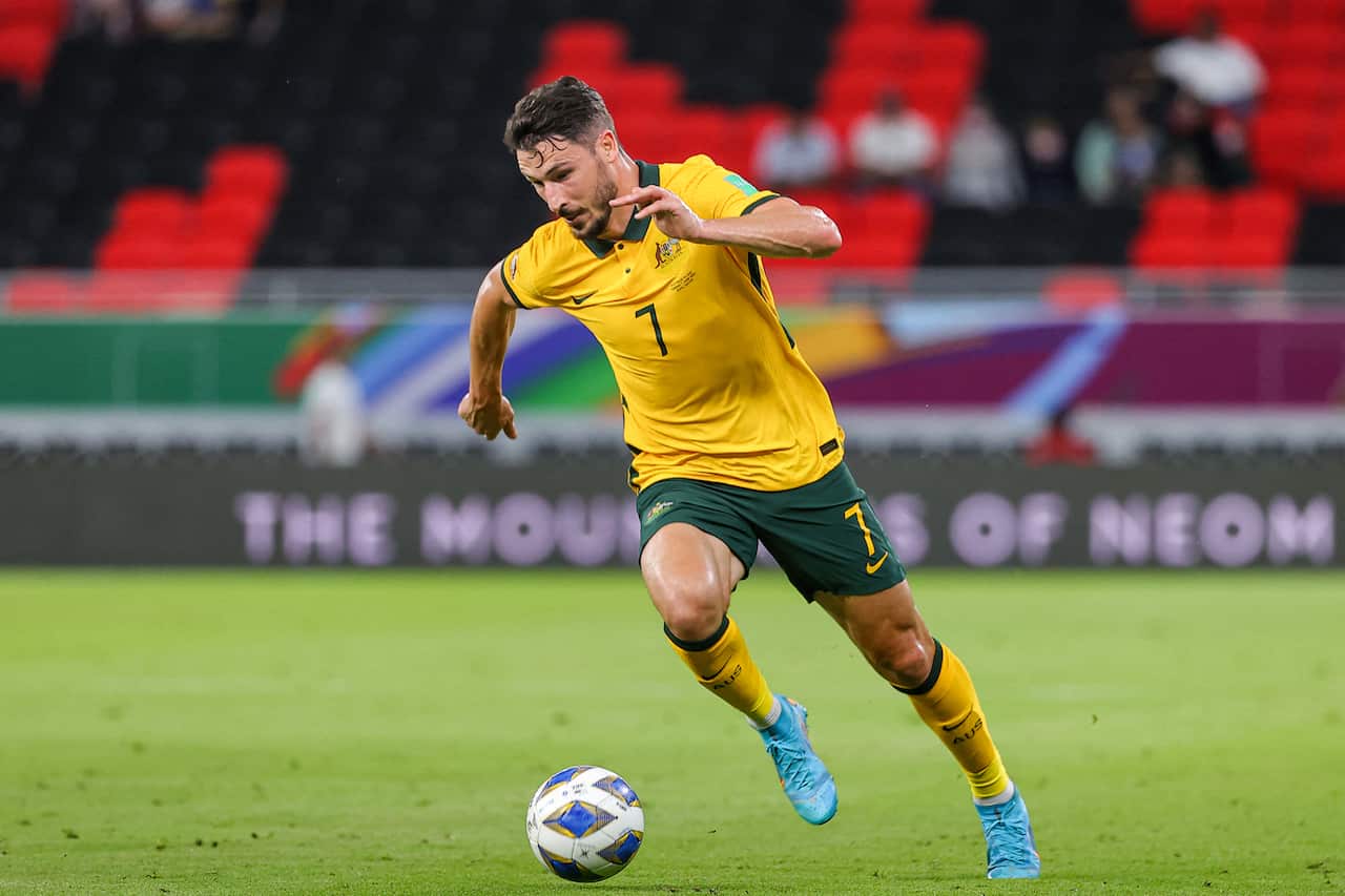 A man kicking a football.