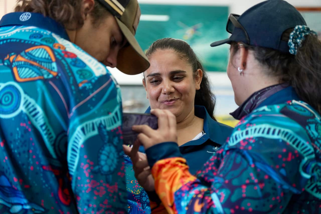 Woman smiling as she looks at phone