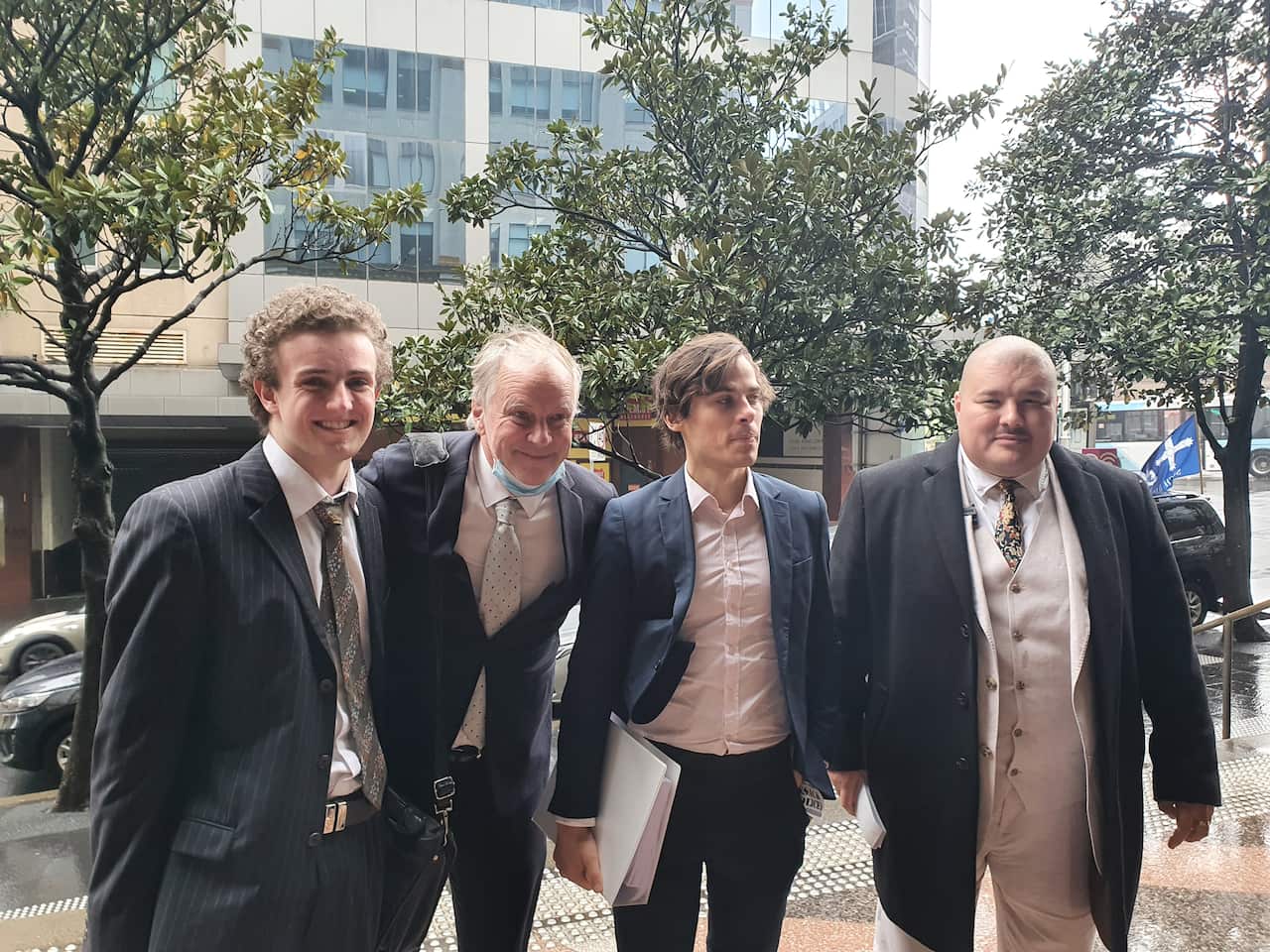 Four men wearing suits.