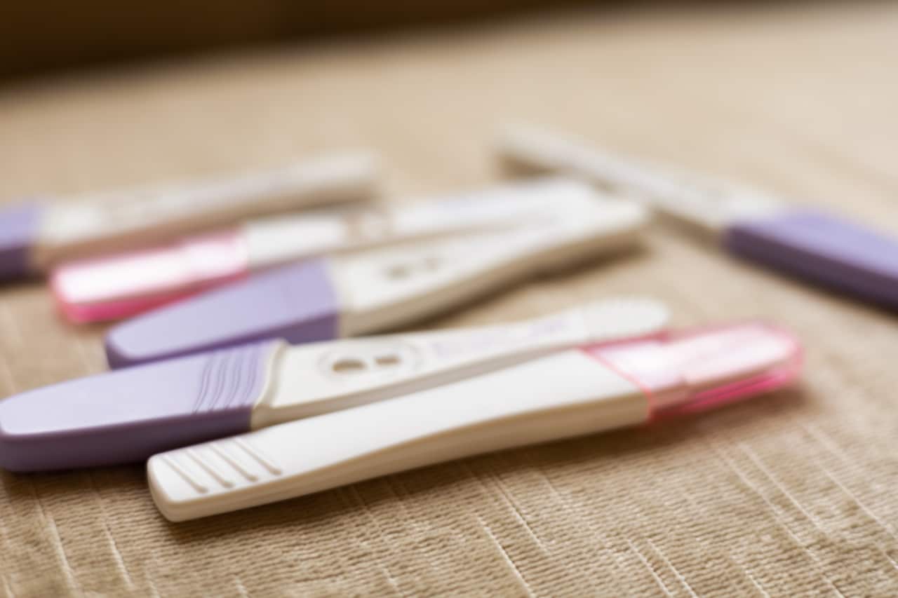 An assortment of home pregnancy tests laid on a surface.