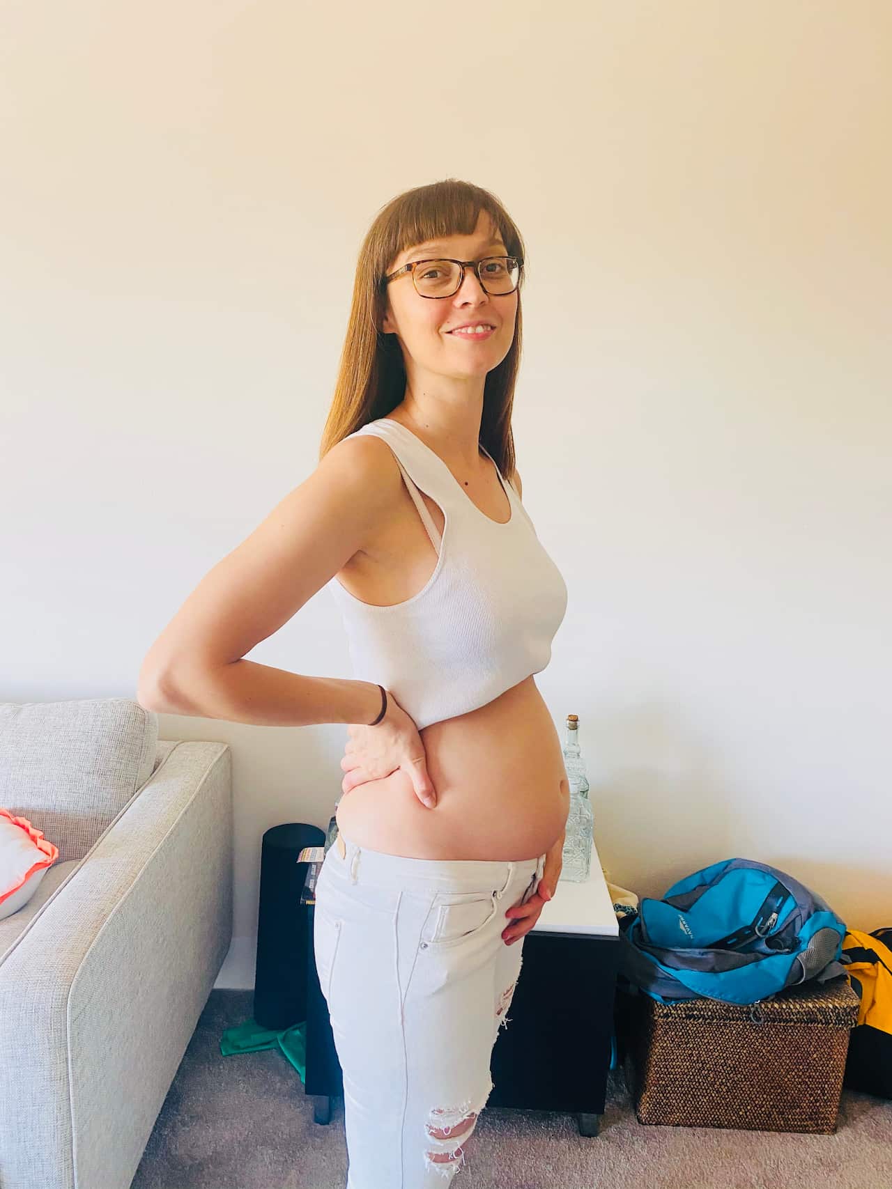 woman standing holding pregnant belly 