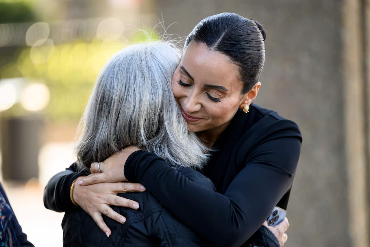 Two women embracing.
