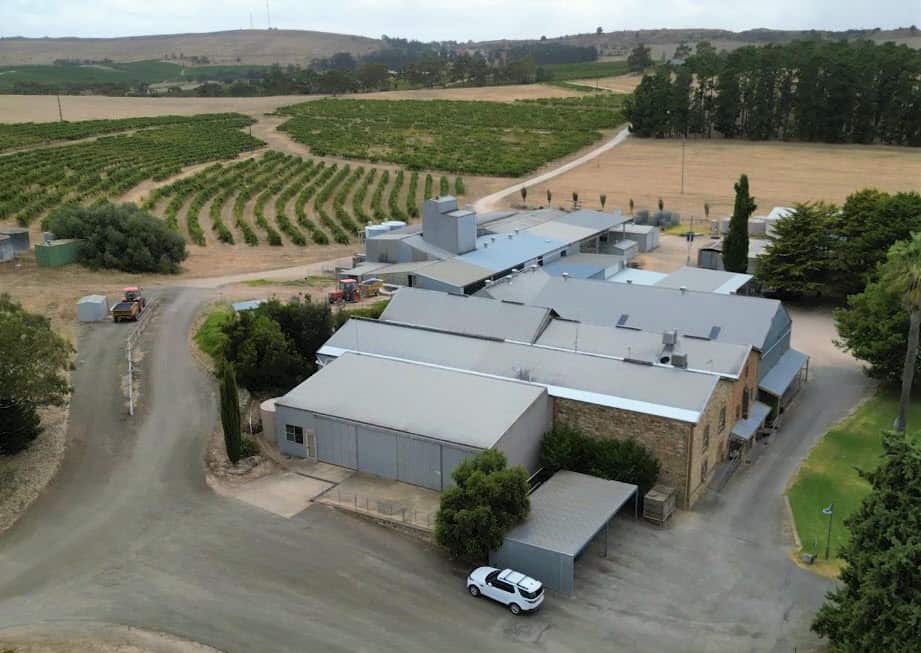An aerial view of winery buildings set in a vineyard.