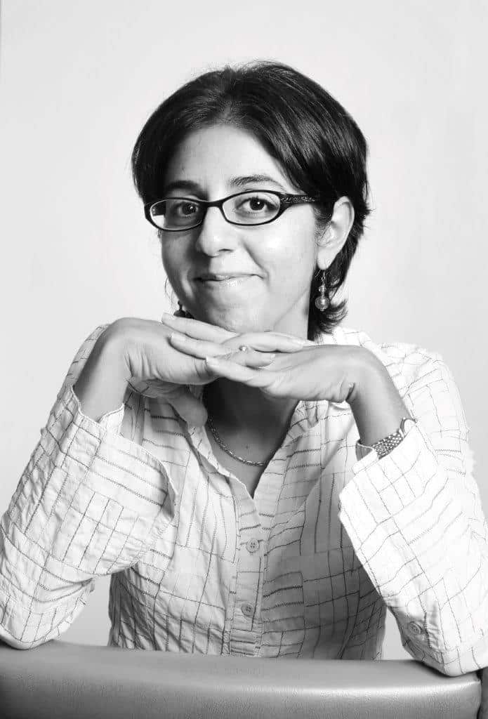 A woman with glasses posing. 