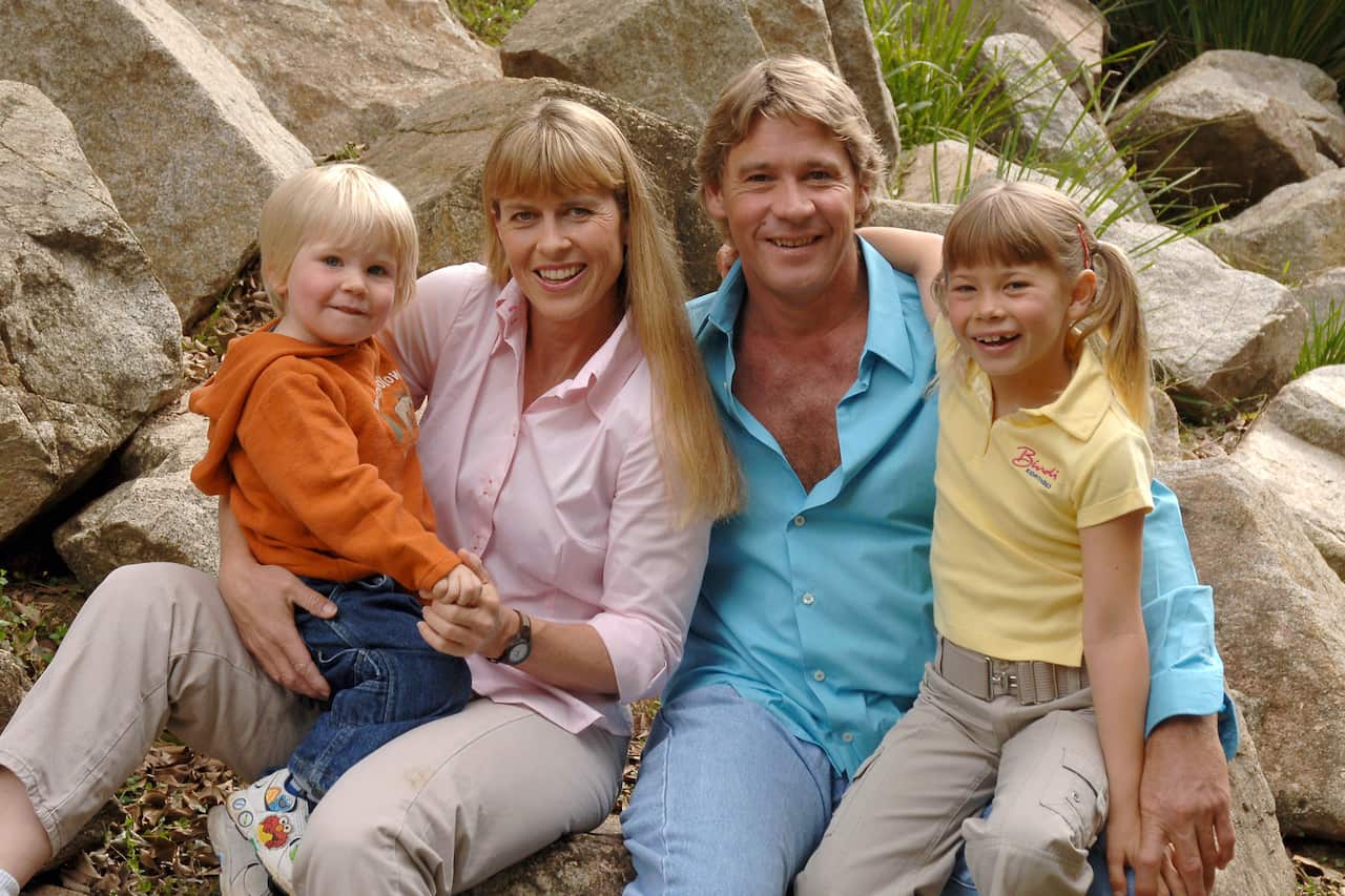 Steve Irwin with his wife and children, smiling as they pose for a photo