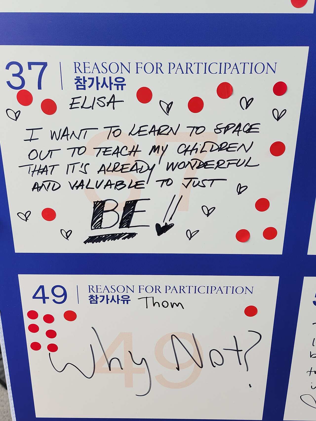 A blue and white piece of paper covered in red stickers with black text reading: "I want to learn to space out to teach my children that it's already wonderful and valuable to just be."