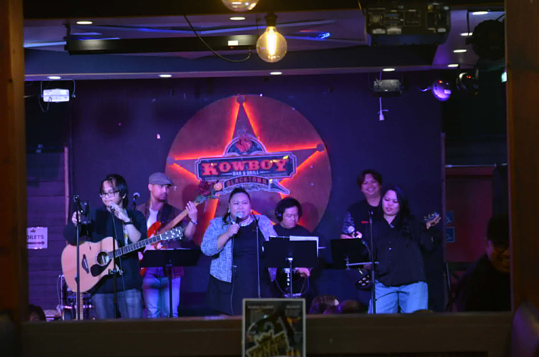 Canberra-based Kapital Kultura Band is a six-member group championing Filipino music, with Belle Summer on lead vocals, Janice Esguerra on backing vocals, Albert Esguerra on drums, Carl Burog on guitar, Miguel Cuevas on bass guitar and vocals, and John on guitar and vocals.