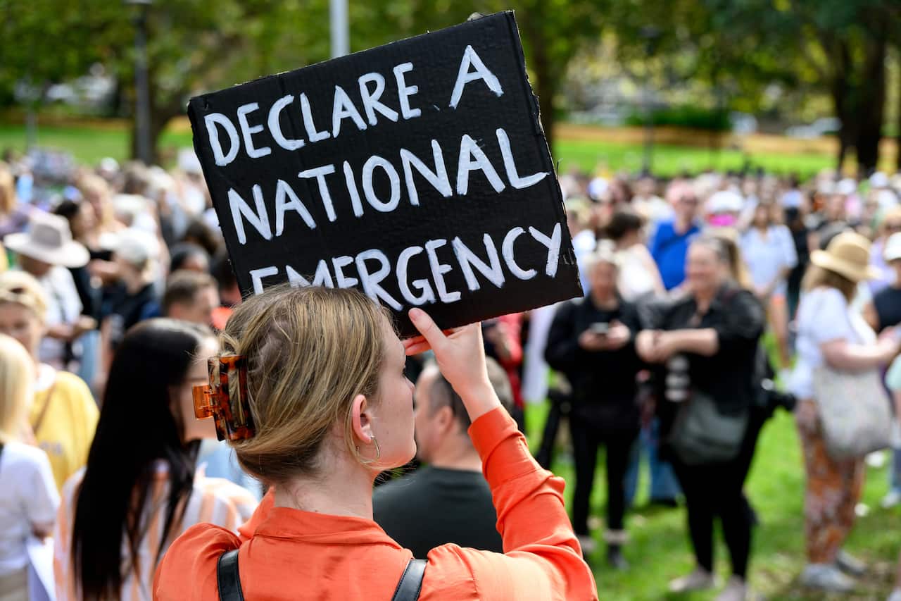 A women holds up placard during a rally to a call for action to end violence against women 