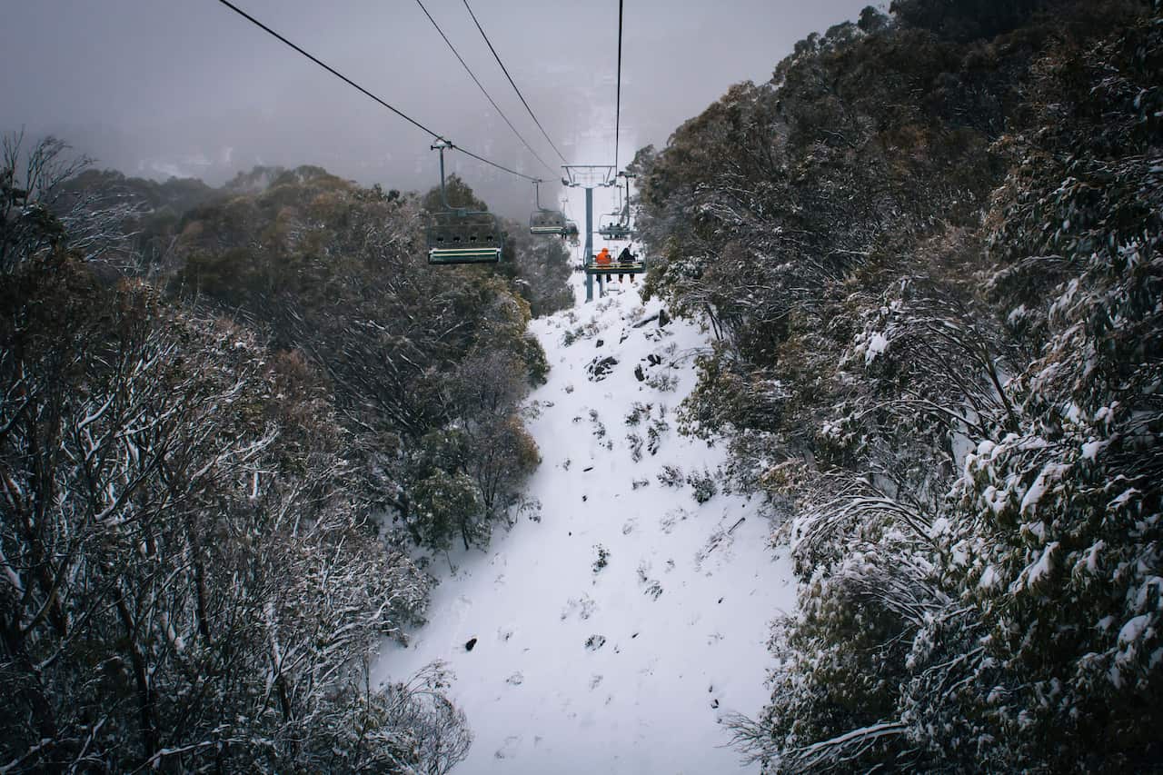 Scenic chairlift over snow-covered wilderness in Mount Buller