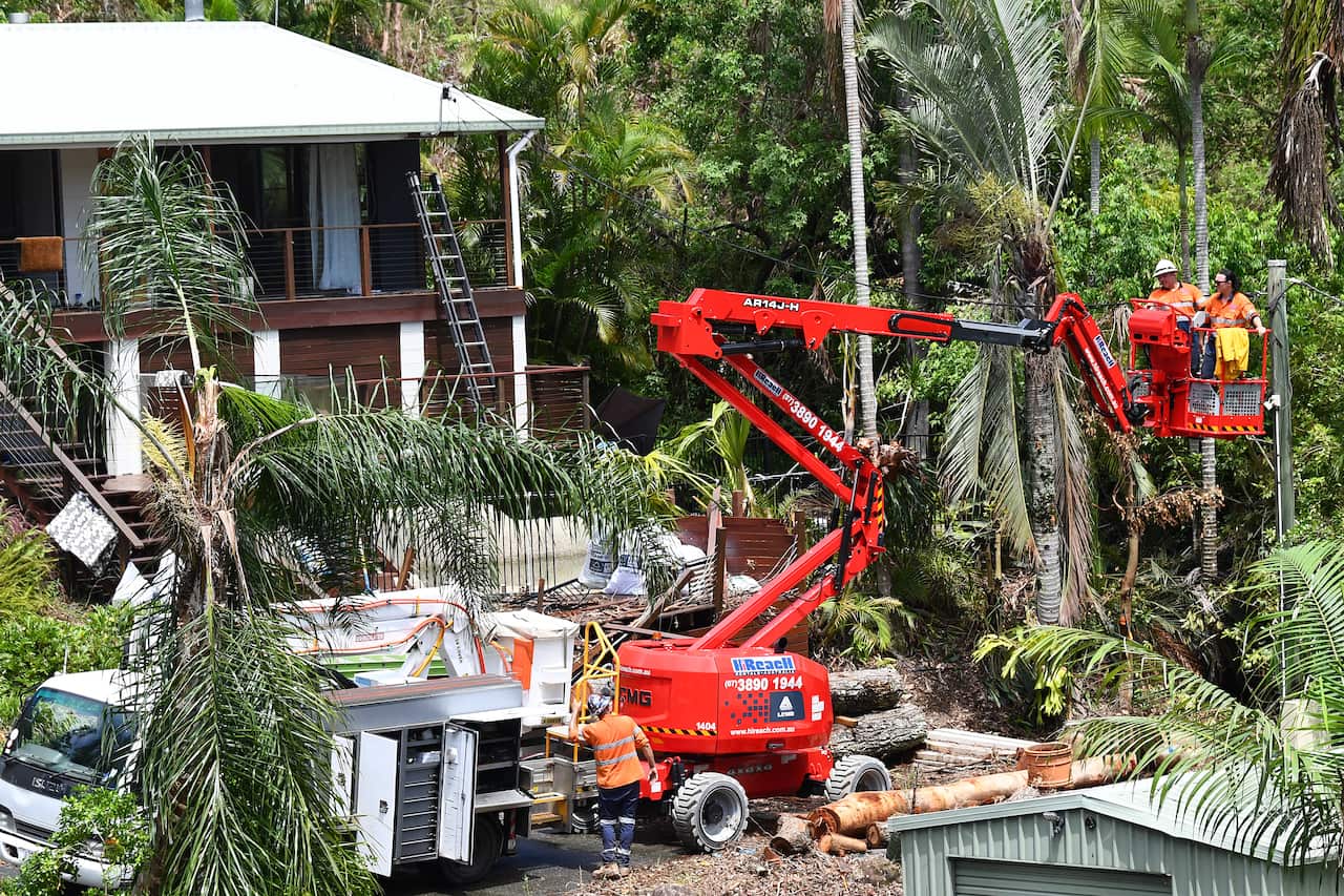 Wokers help clear up storm damage
