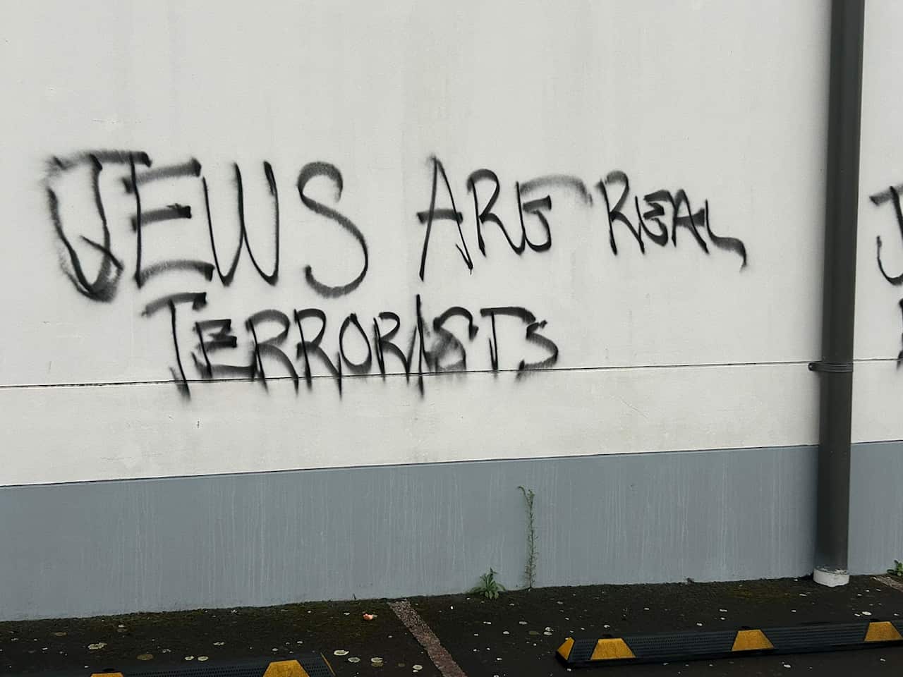 Graffiti painted on a wall that reads "Jews are real terrorists".