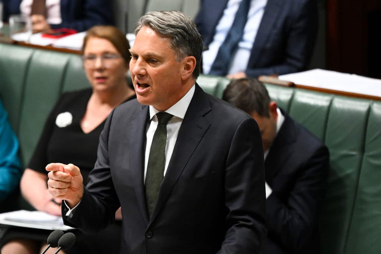 Man in suit speaks in the House of Representatives.