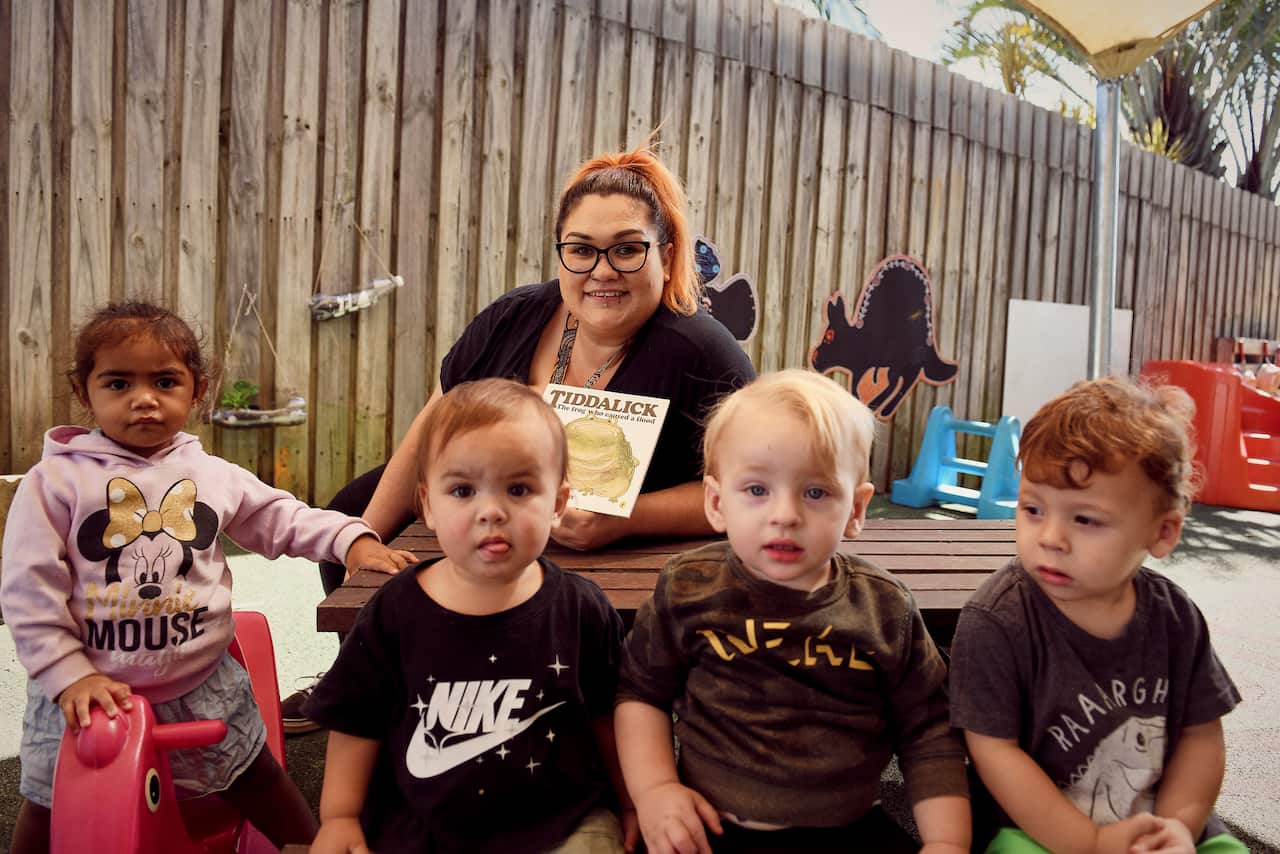 Photo of Alinta Pencheff-Scott with preschool children.
