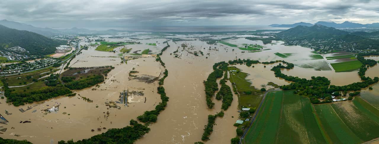 An aerial shot of a brown flooded river