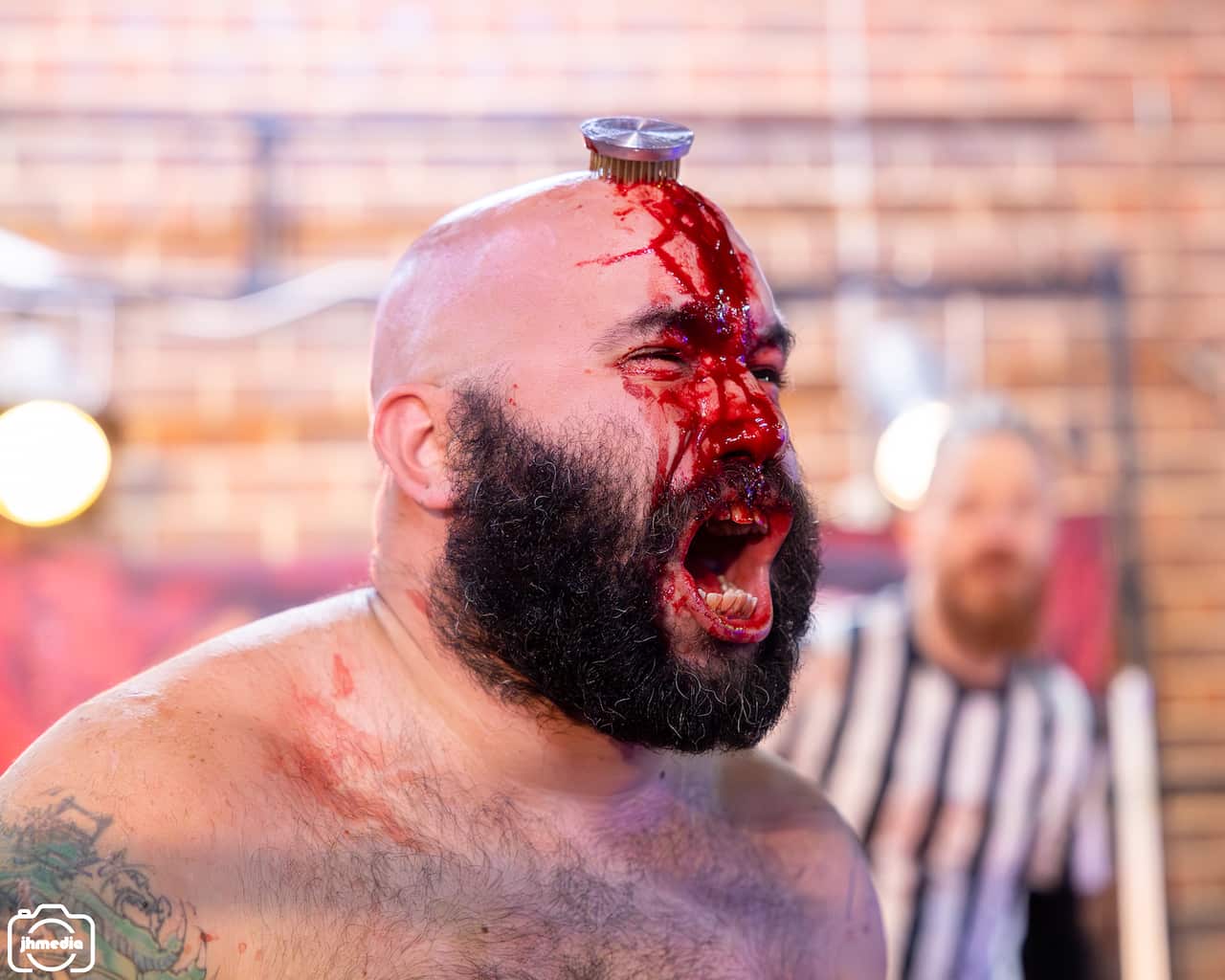 A man with a weapon in his forehead bleeding. 