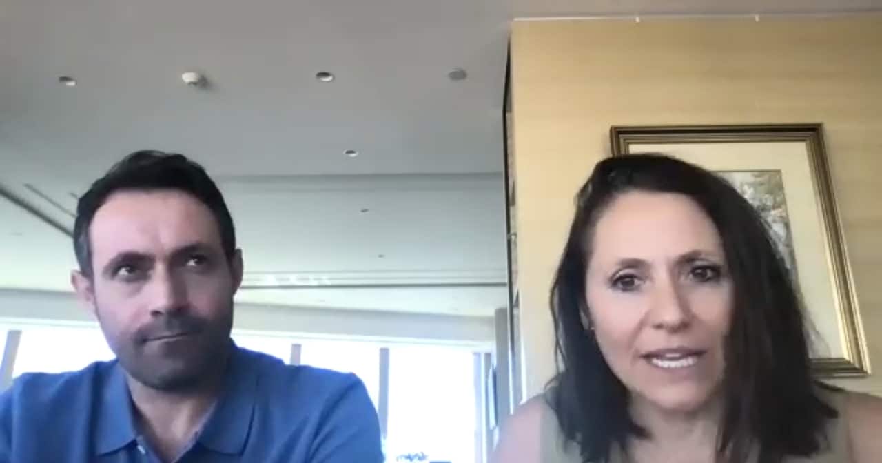 A screenshot of a man in a blue polo shirt and a woman with shoulder-length brown hair.