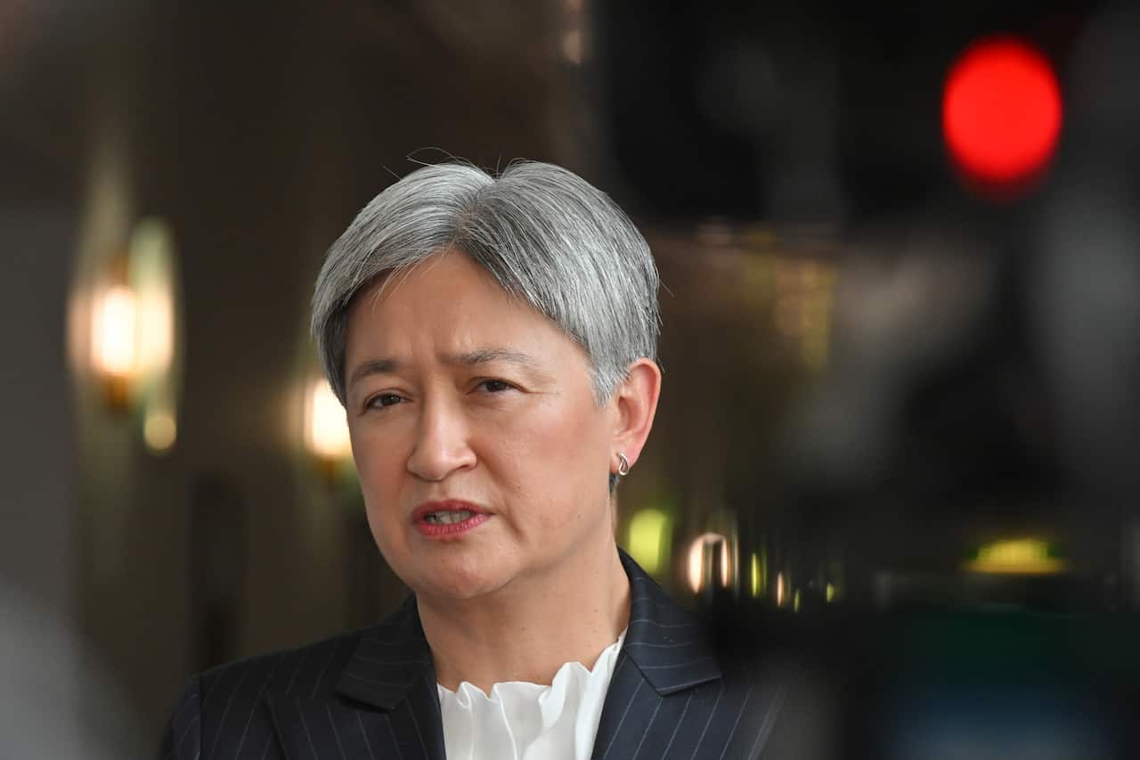 Penny Wong standing in a hallway.