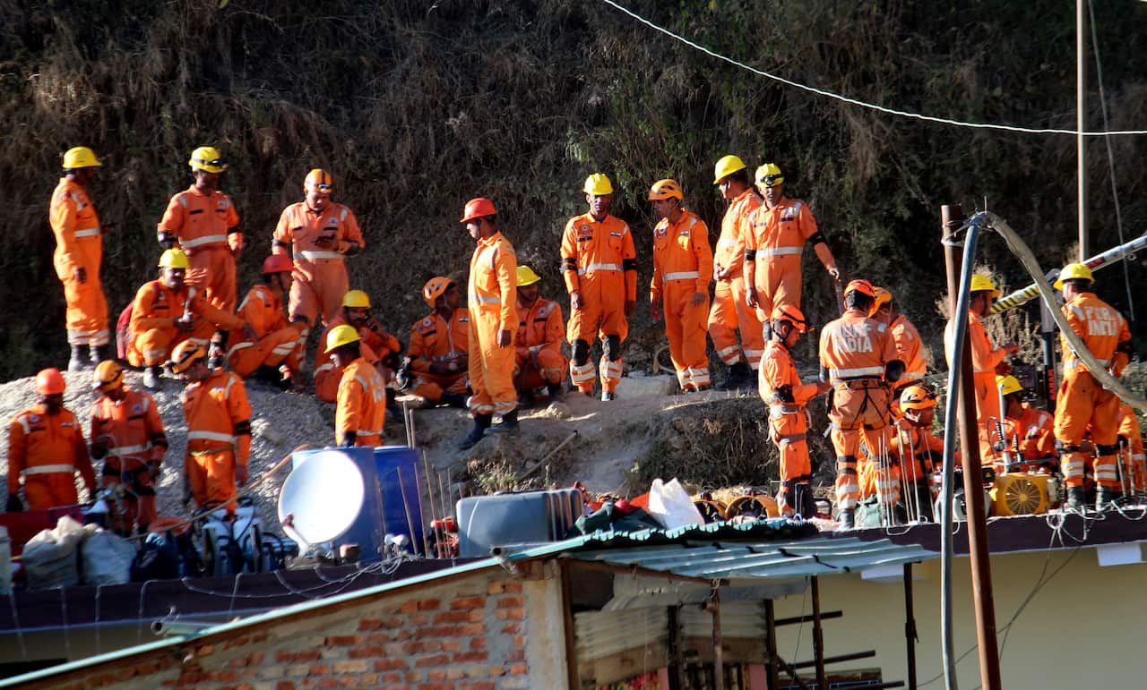 Workers gathered around the collapsed tunnel. 