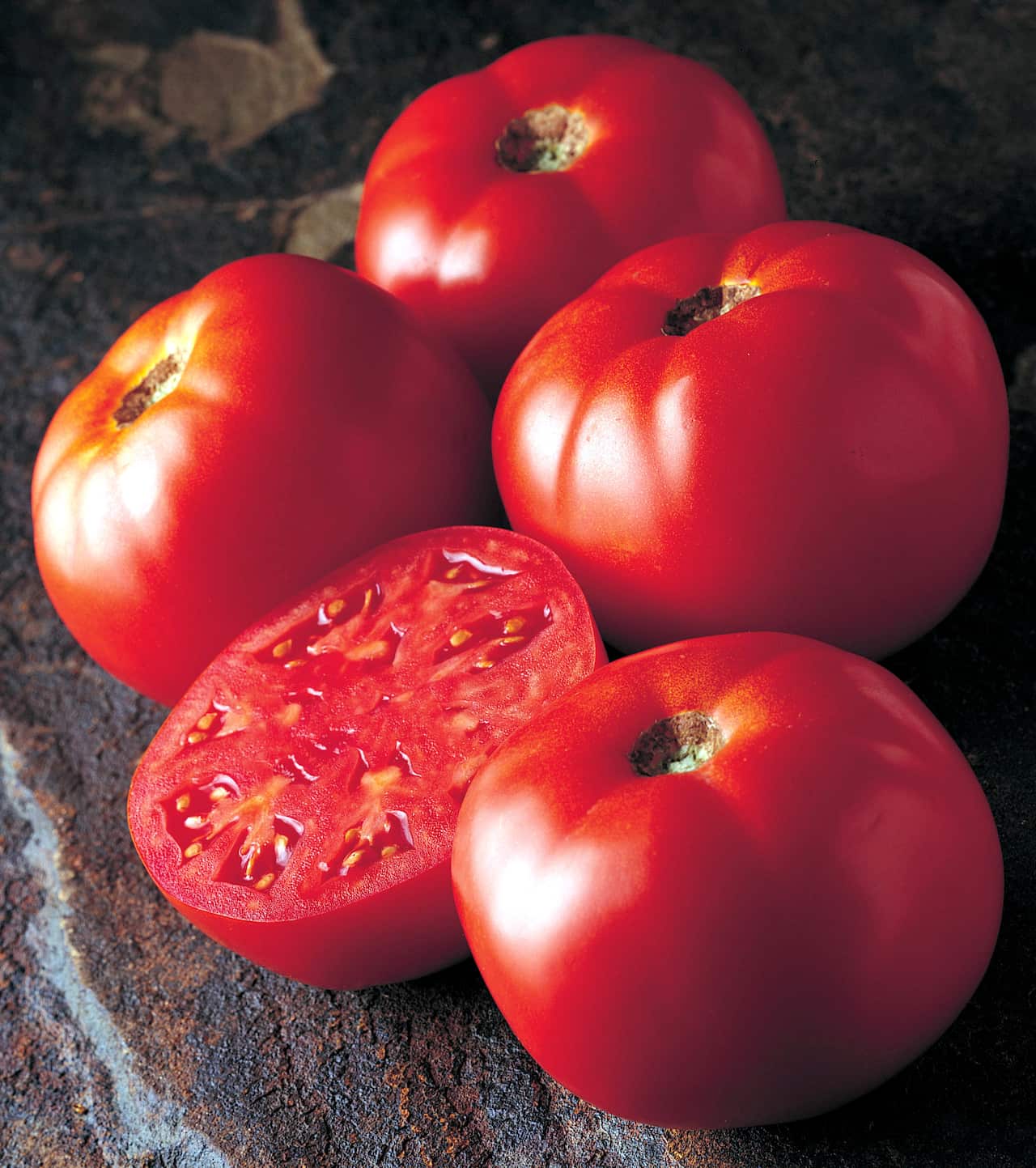Some tomatoes, one cut in half