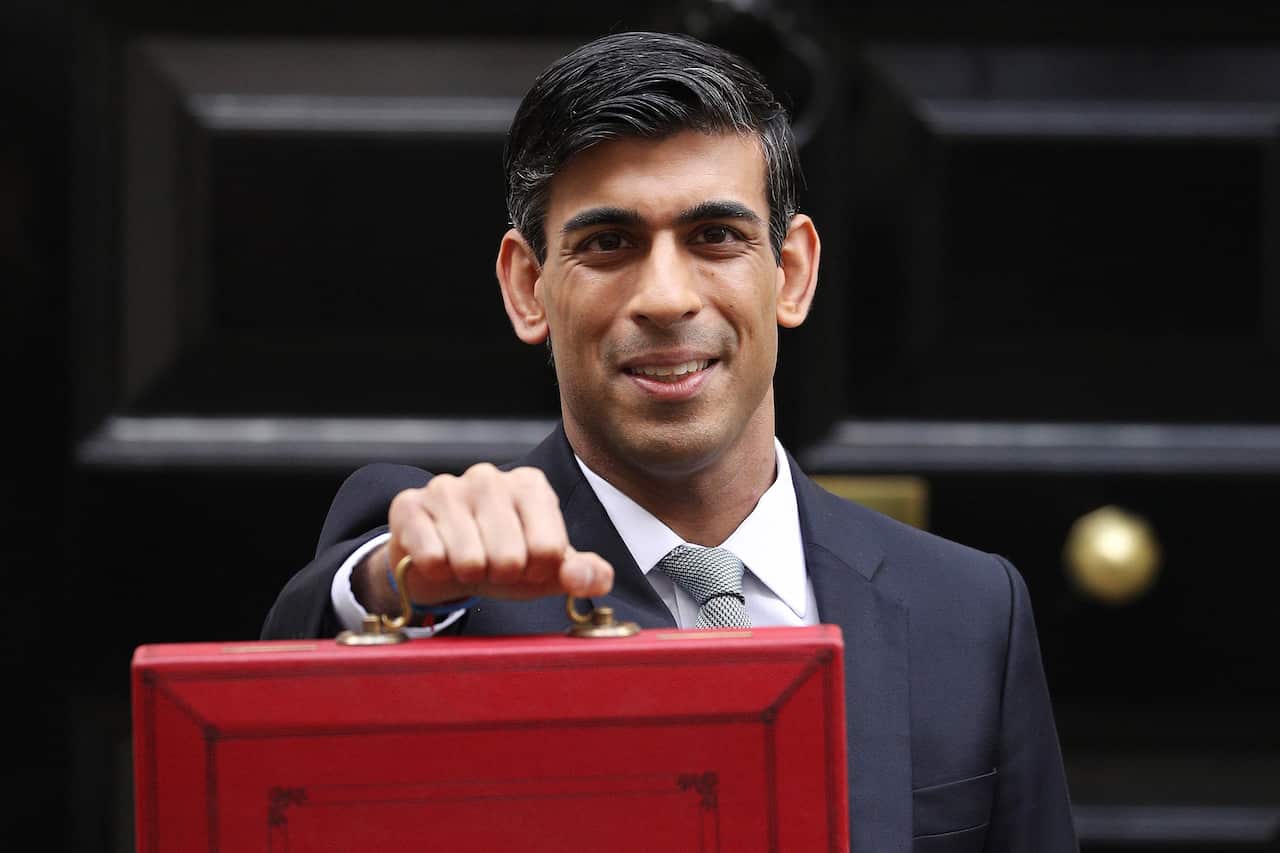 Rishi Sunak in a suit holding a red briefcase. 