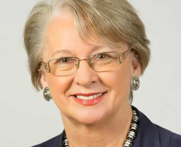 Close up picture of a woman smiling.