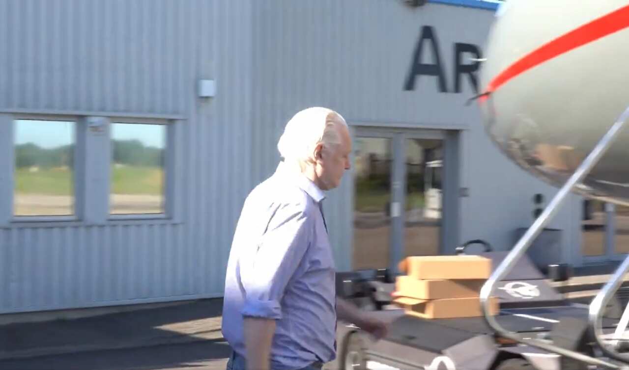 A man walking to board a plane