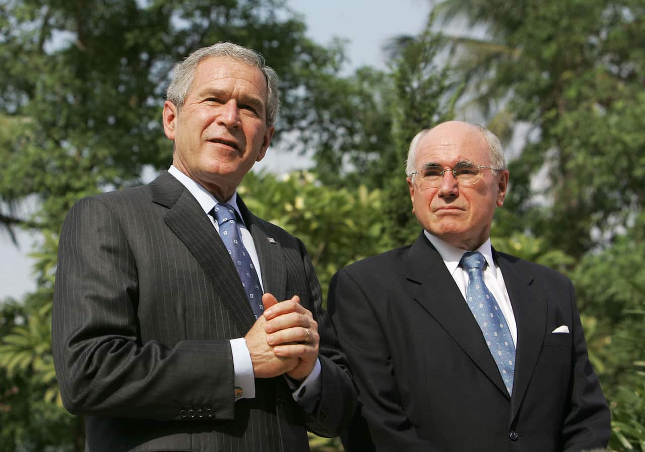 Two men in suits standing outside 