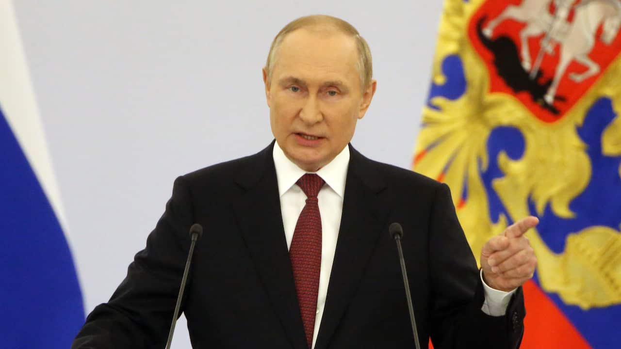 Vladimir Putin speaking into microphones