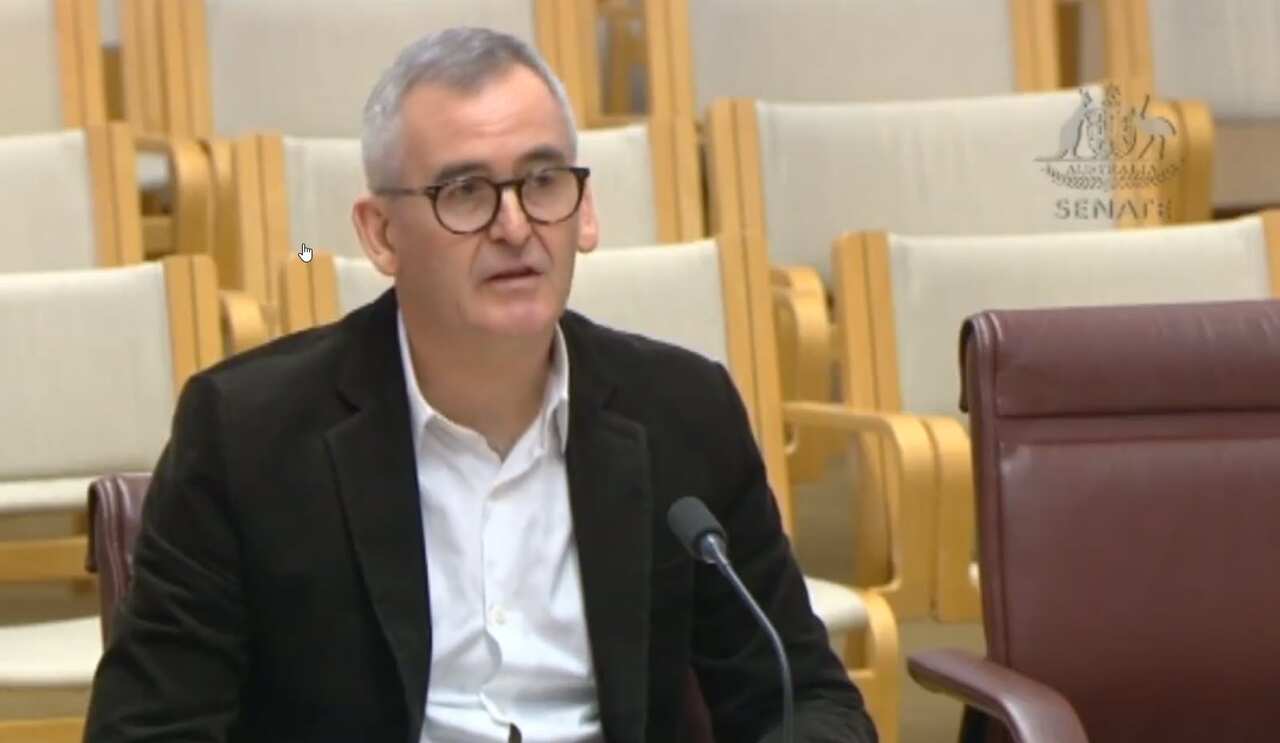 A man wearing a suit and glasses