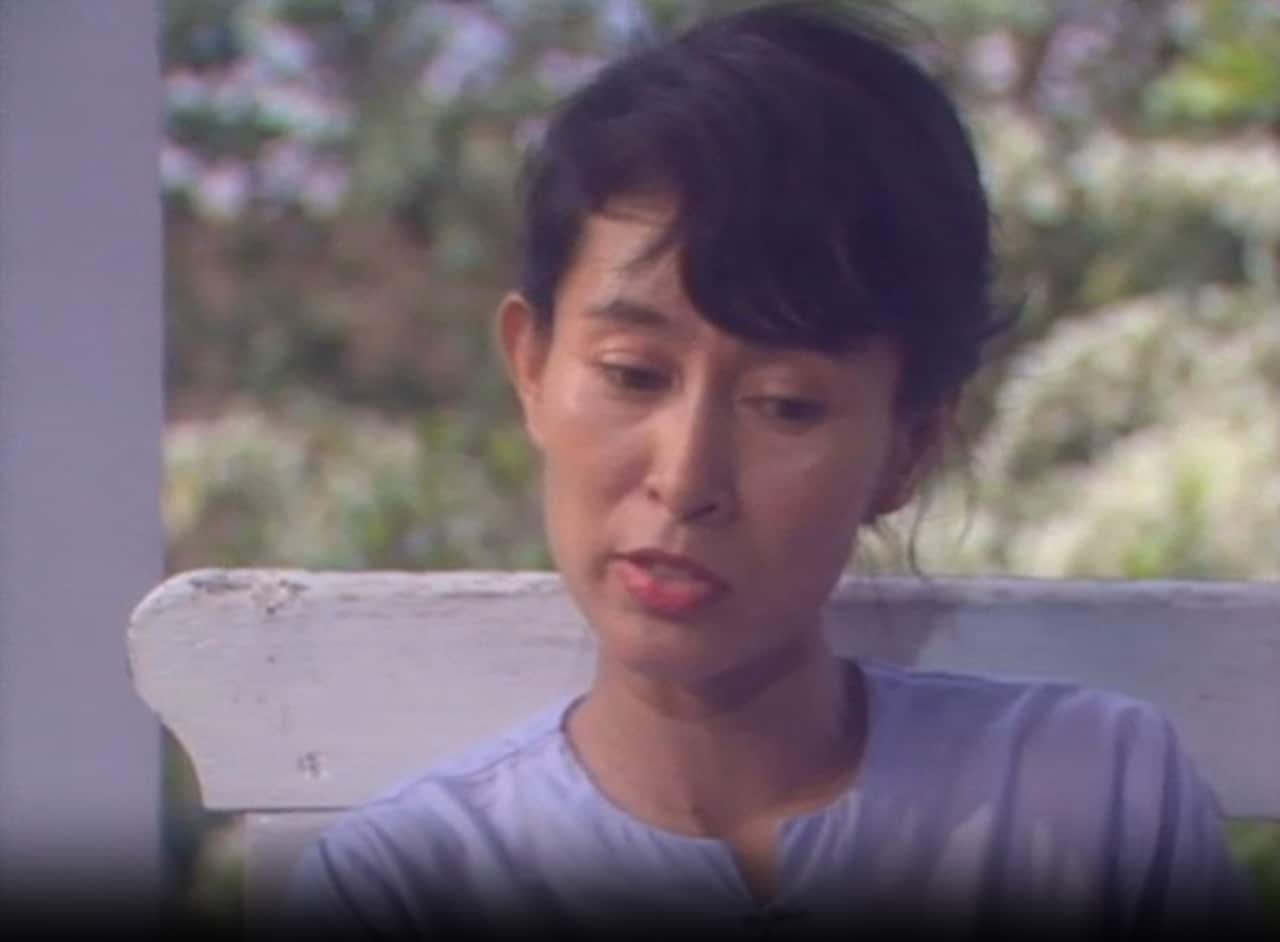  Aung San Suu Kyi with dark hair and pink lipstick