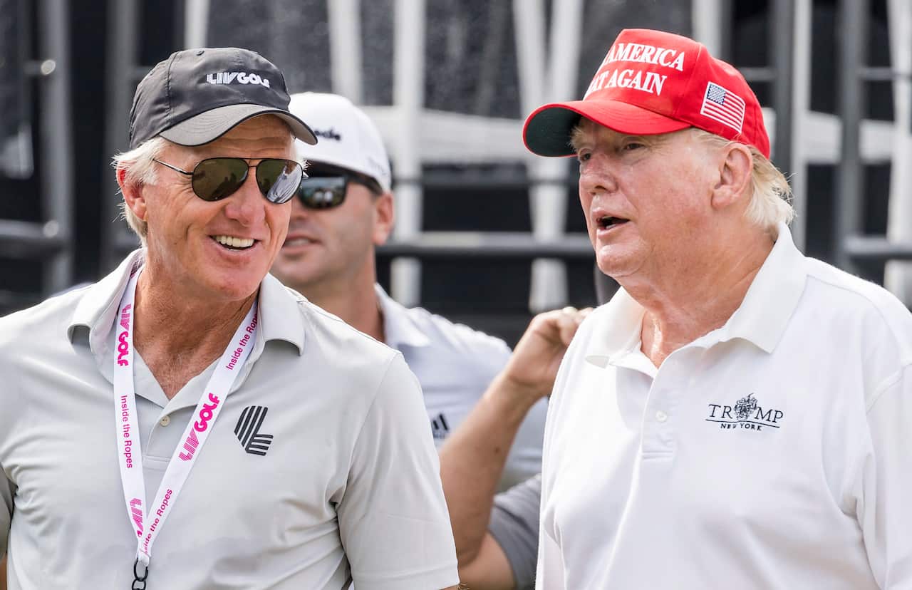 Former US president Donald Trump is seen talking with Greg Norman during a Pro-Am tournament leading up to the LIV Golf Bedminster invitational, part of the new LIV Golf Invitational Series, at the Trump National Golf Club in Bedminster, New Jersey on 28 July 2022. 