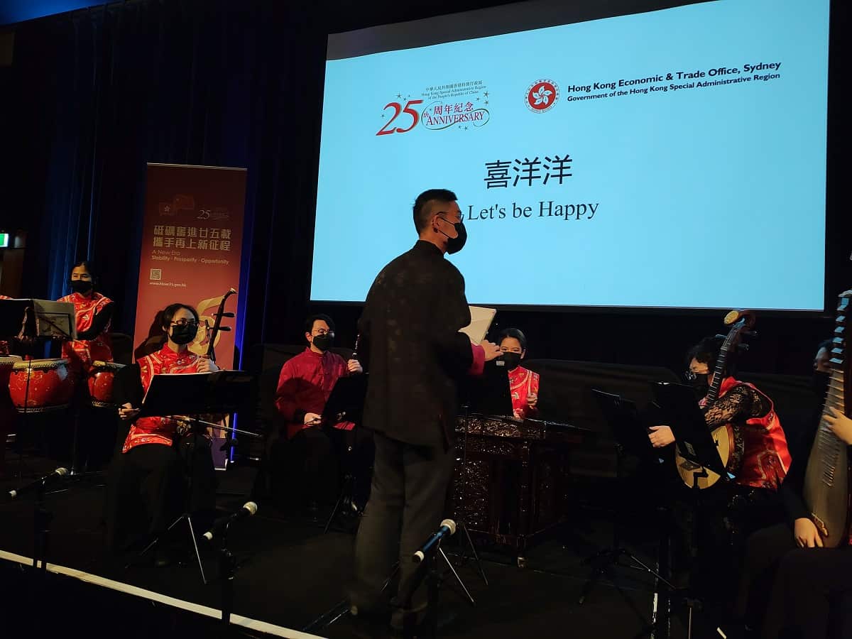 Eric Lau conducts  Let's be Happy at a HKETO event