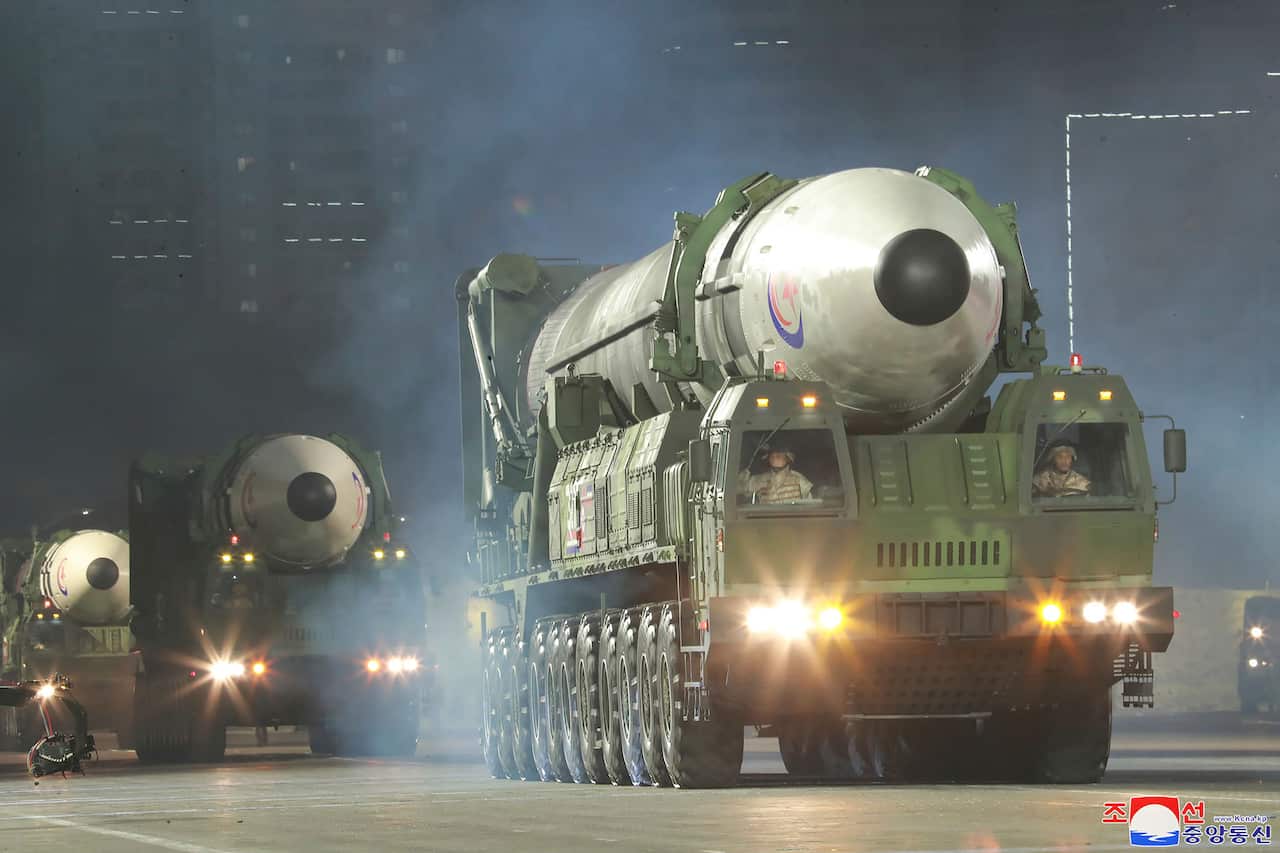 Three heavy vehicles carrying missiles.