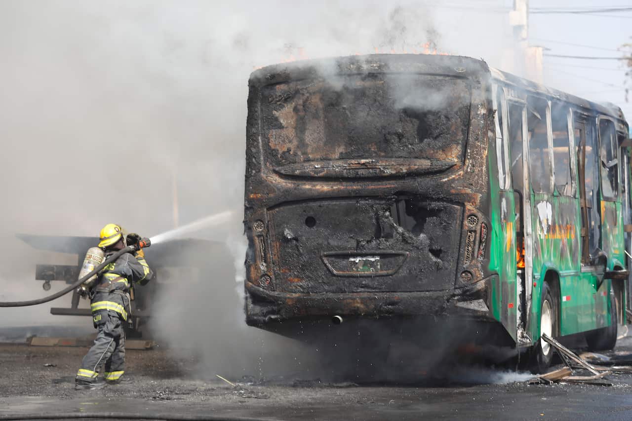 Members of organized crime block roads in western Mexico with burning cars