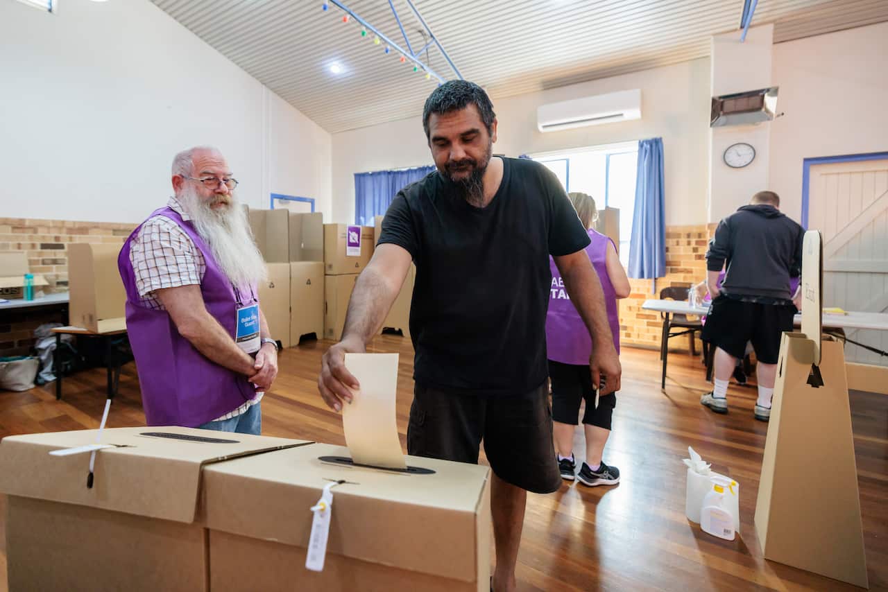 Man putting his vote in a ballot box