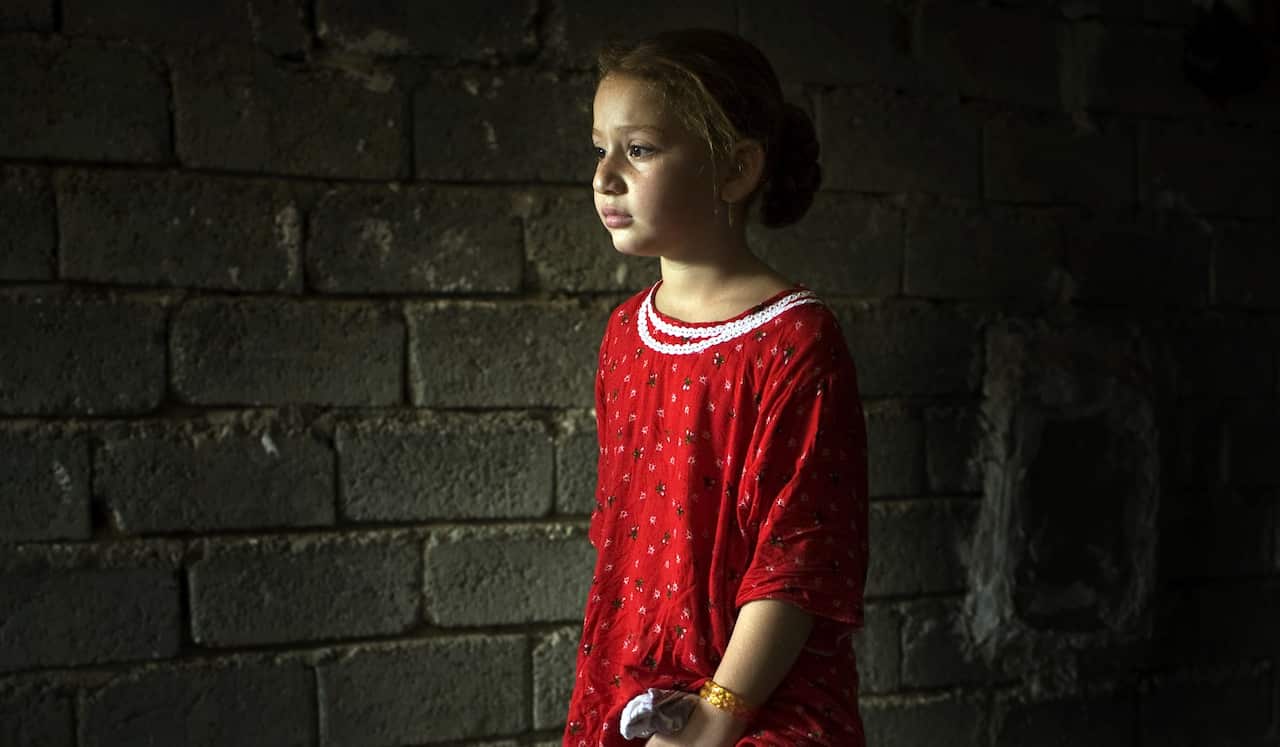 A seven-year-old girl cries after FGM was performed on her. 