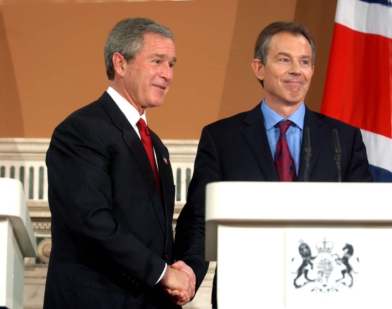 George W. Bush (left) and Tony Blair shake hands at a press conference.