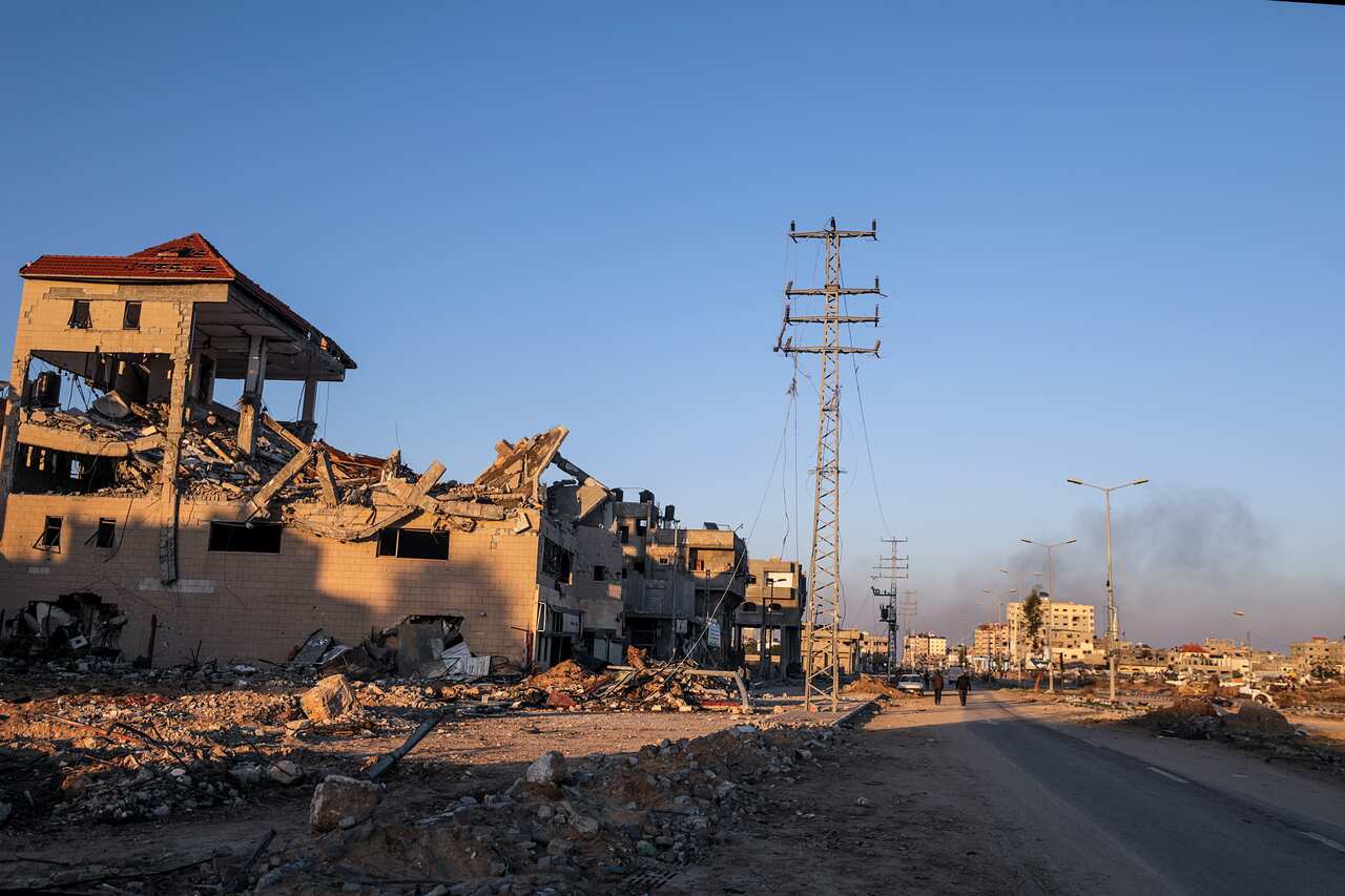 Destroyed houses and rubble on a street.