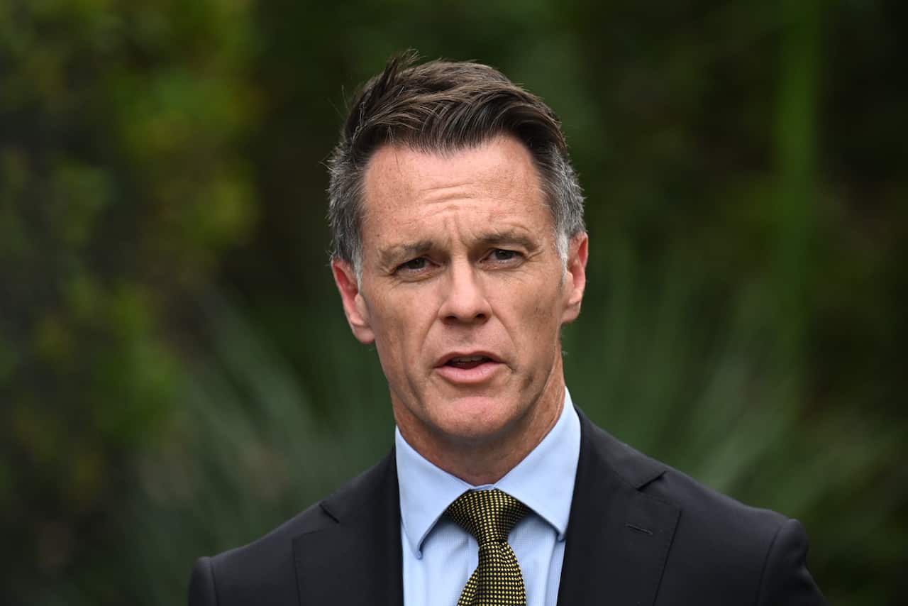 A man in a suit and tie is speaking.