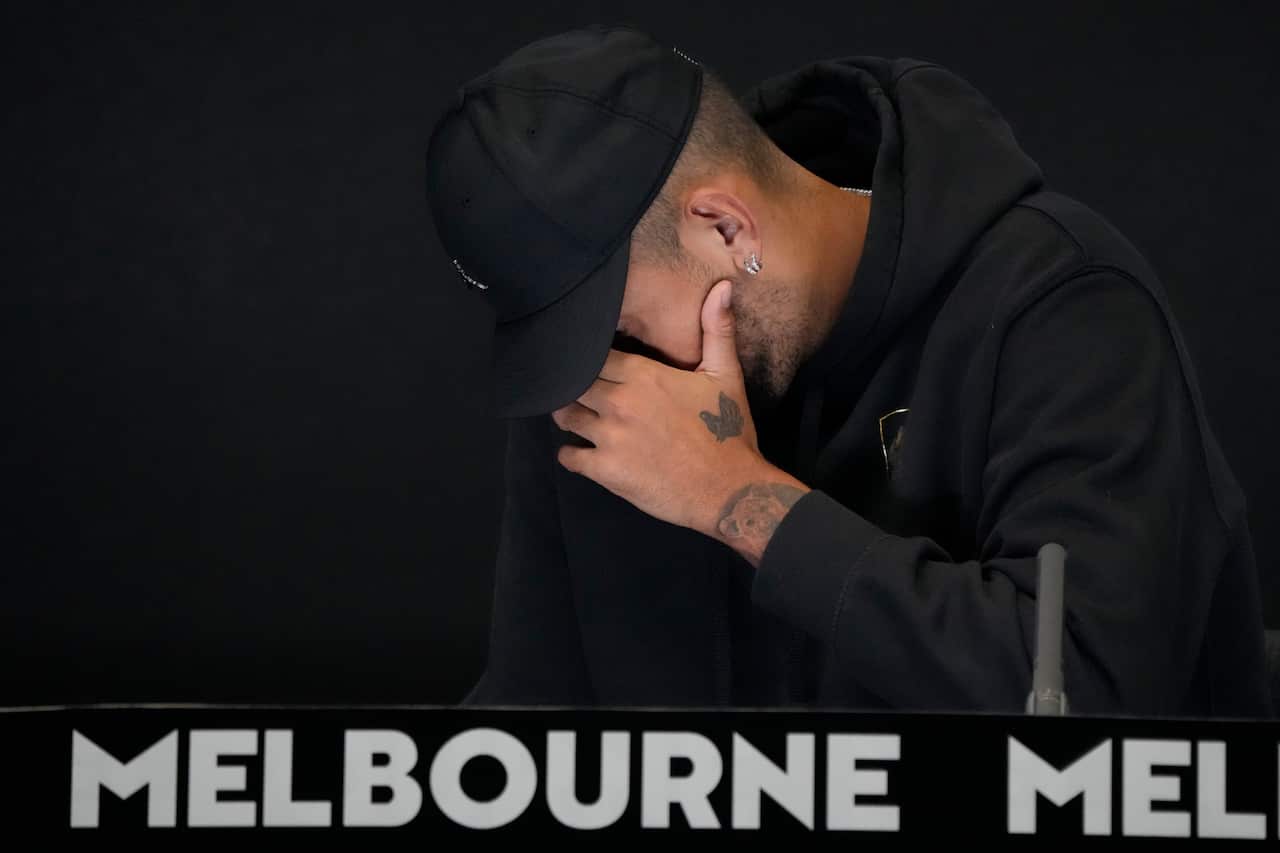 Nick Kyrgios in a black cap and hoodie