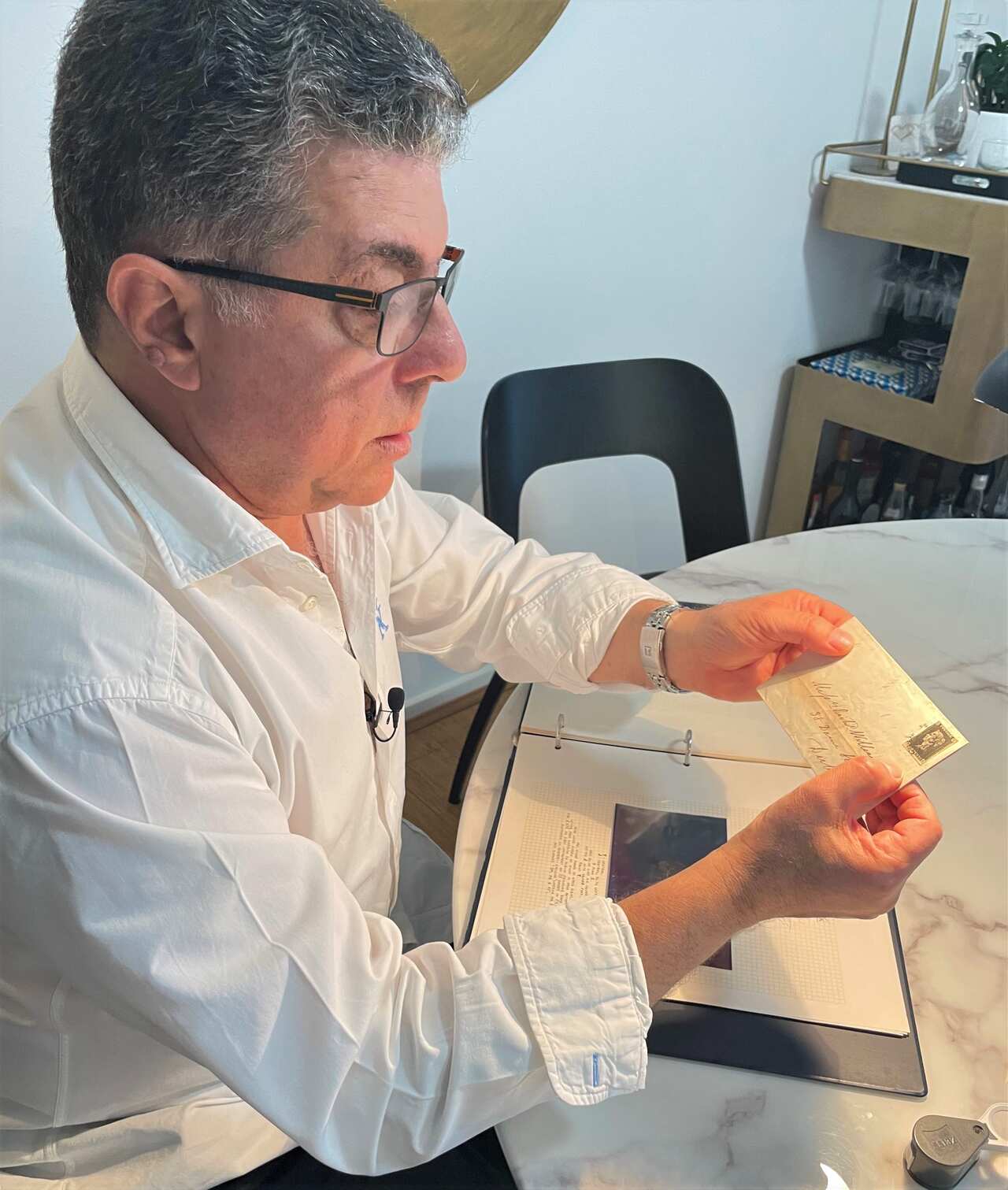 Michel Roussos values stamps at home 