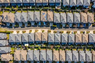 An aerial view of dozens of houses on compact blocks.