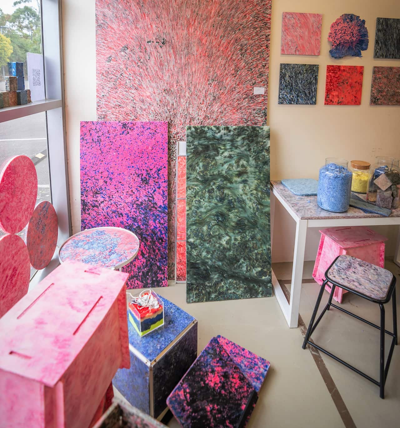 A range of colourful boards and chairs arranged in a display showroom.