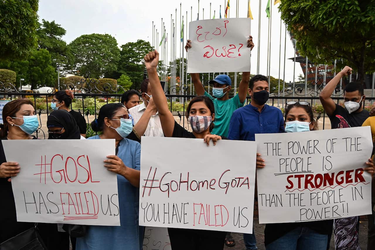 Protestors hold banners and placards during a demonstration against the surge in prices and shortage of fuel and other essential commodities in Colombo.