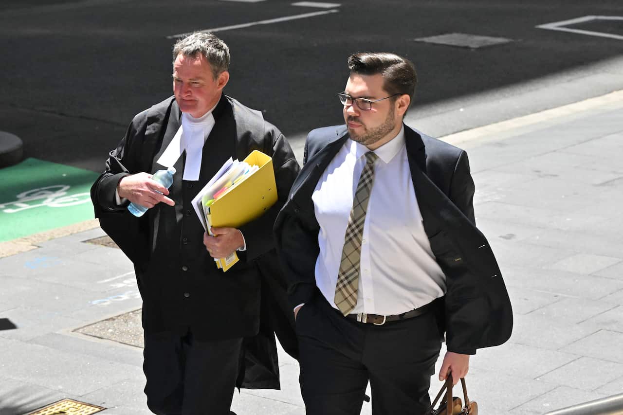 Two men walking outside a court