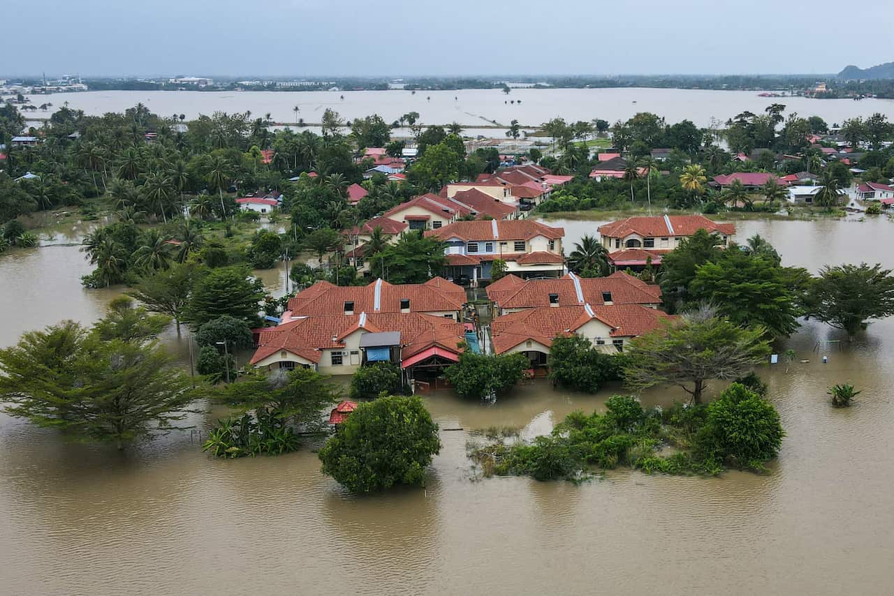 An aerial view shows residential areas surrounded by flood waters
