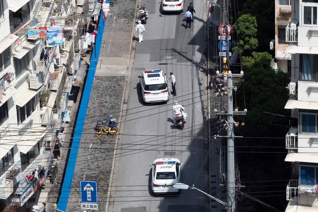 Aerial view of three police cars on a suburban road.