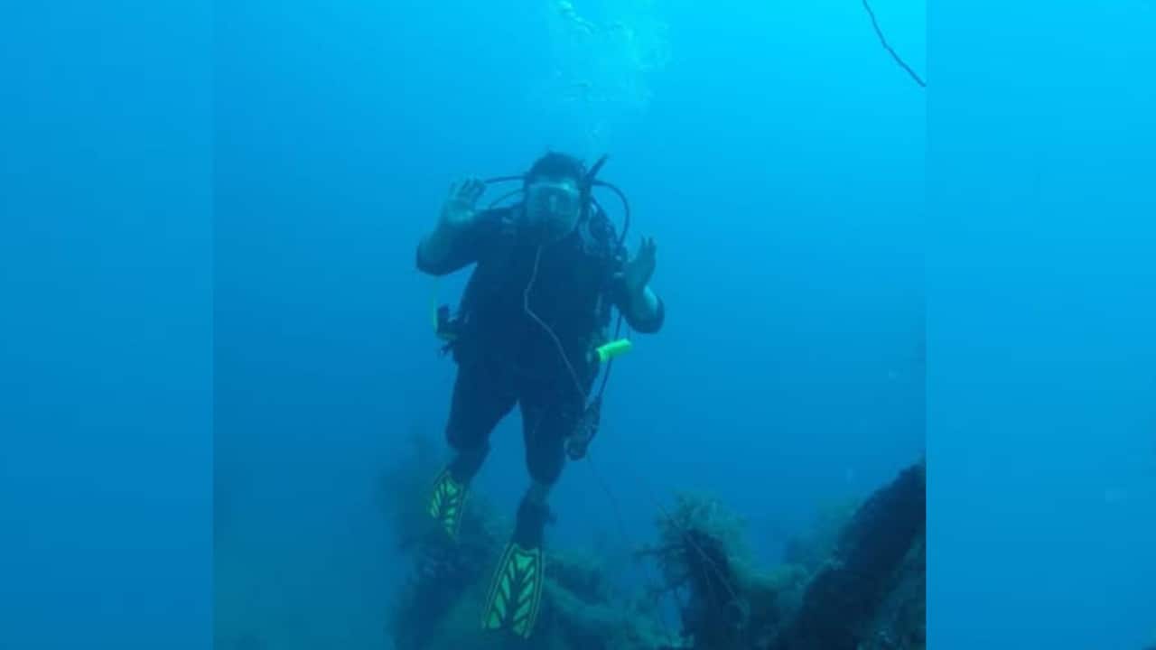 a woman scuba diving in the ocean underwater